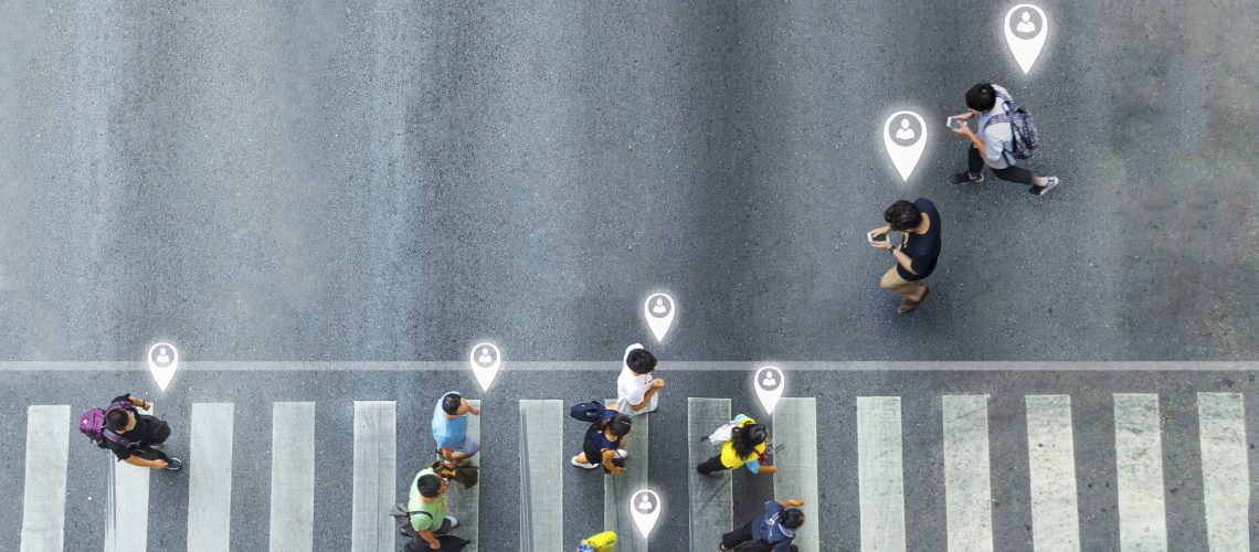 Aerial view and top view with blur man with smartphone walking converse with busy city crowd move to pedestrian crosswalk. concept art of person icon connecting.